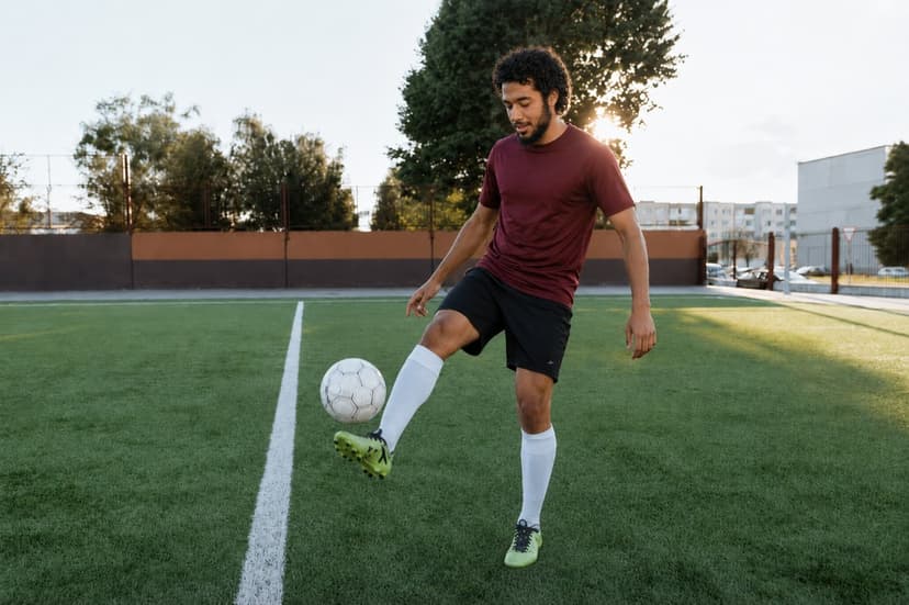 A young man playing football on an outdoor field